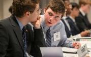 Two students sitting at a table.